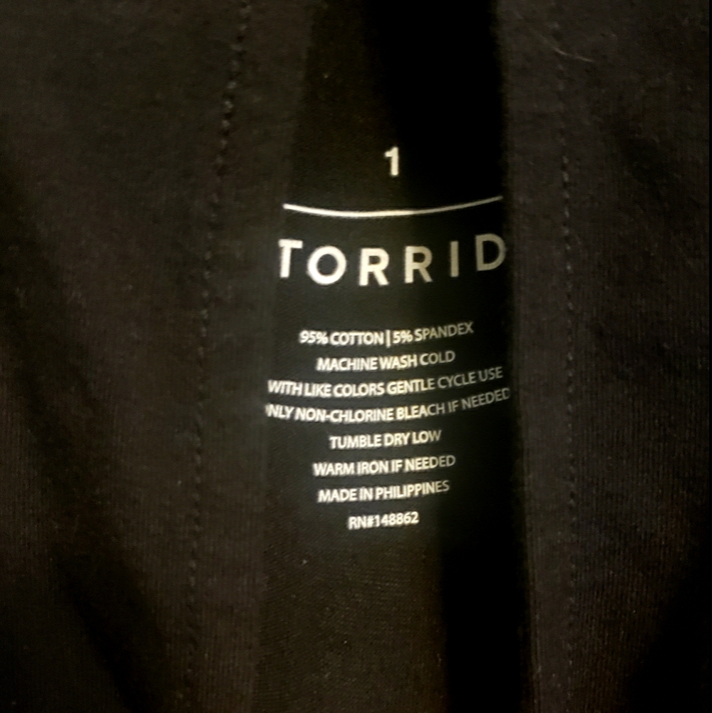A black long sleeve peek- a- boo shoulder shirt